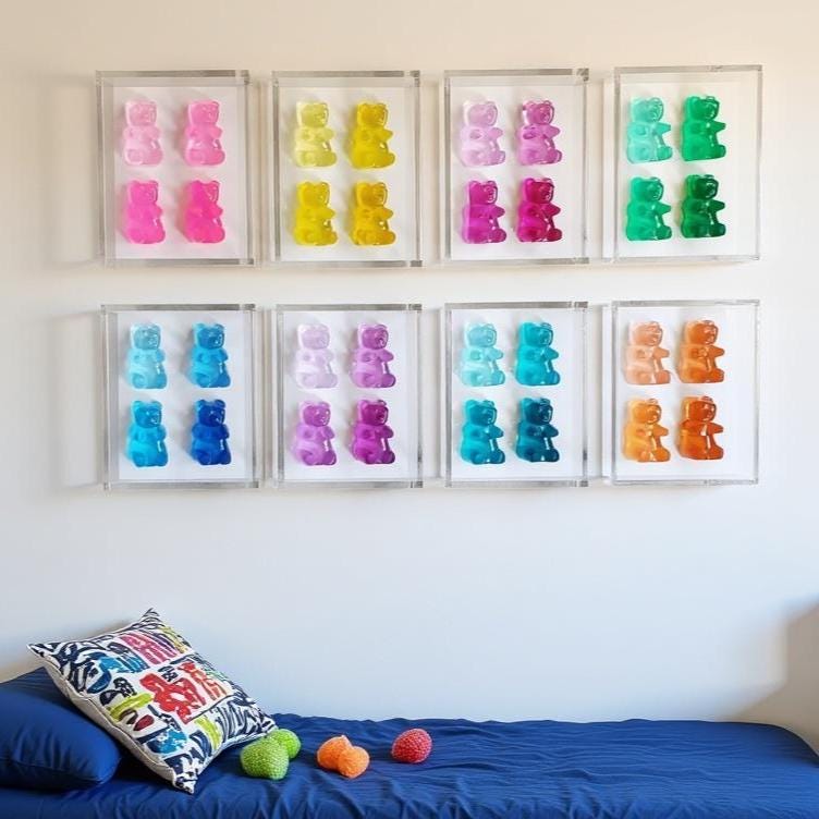 A radiant fusion of nostalgia and modern luxury, this jewel‑tone gummy bear sculpture is meticulously cast in premium resin and displayed within a museum‑grade, UV‑protected shadow box. Each bear glows with gemstone richness—deep sapphire, amethyst, ruby, citrine, or emerald tones—capturing light like a miniature piece of candy‑inspired fine art.